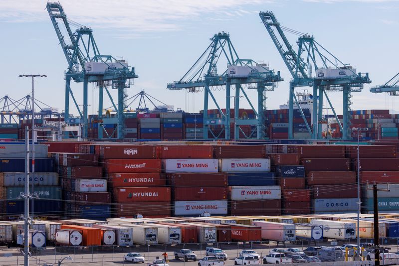 FILE PHOTO: Stacked containers and cranes are shown at the Port of Los Angeles in Los Angeles, California, U.S., November 22, 2021. REUTERS/Mike Blake/File Photo