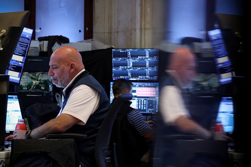 FILE PHOTO: Traders work on the floor at the New York Stock Exchange (NYSE) in New York City, U.S., July 21, 2025.  REUTERS/Brendan McDermid/File Photo