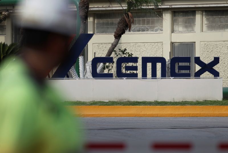 FILE PHOTO: A worker walks past outside the main entrance from a concrete plant of Mexican cement maker CEMEX, in Monterrey, Mexico June 8, 2021. Picture taken June 8, 2021. REUTERS/Daniel Becerril/File photo