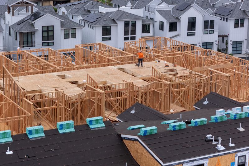 FILE PHOTO: A drone view shows a construction worker taking a break to hydrate while working on a multi-home residential project by Shea Homes in Encinitas, California, U.S. July 21, 2025.  REUTERS/Mike Blake/File photo