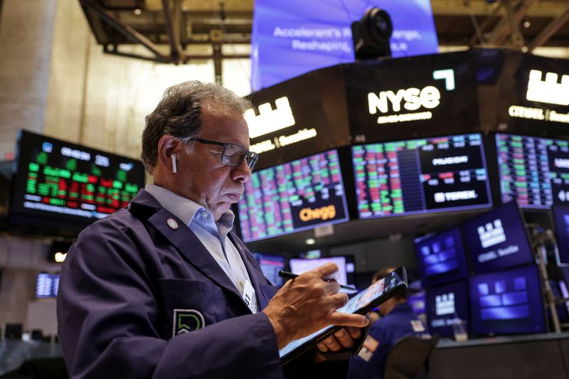 A trader works on the floor at the New York Stock Exchange (NYSE) in New York City, U.S., July 25, 2025. REUTERS/Jeenah Moon