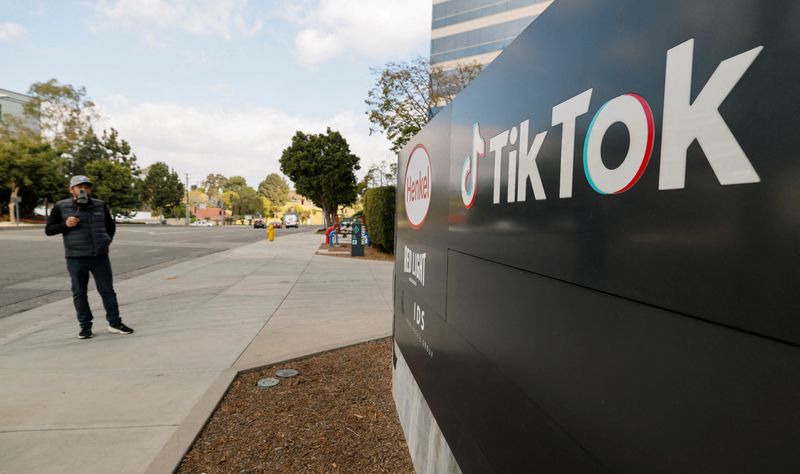 FILE PHOTO: A man films a TikTok video outside the U.S. headquarters of the social media company TikTok in Culver City, California, U.S. January 18,2025.    REUTERS/Fred Greaves/File Photo