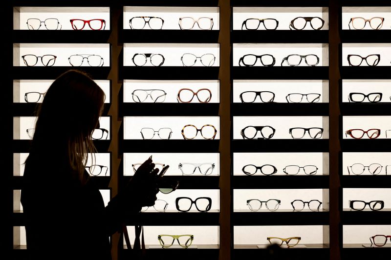 FILE PHOTO: Glasses manufactured by EssilorLuxottica, stand on display in their exhibition space at SILMO in Villepinte, near Paris, France September 24, 2022. REUTERS/Benoit Tessier/File Photo