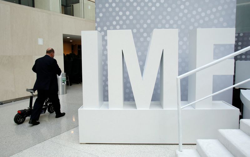 FILE PHOTO: A man takes out a scooter at the International Monetary Fund headquarters after closing of the IMF/World Bank annual meetings in Washington, U.S., October 9, 2016. REUTERS/Yuri Gripas/File Photo