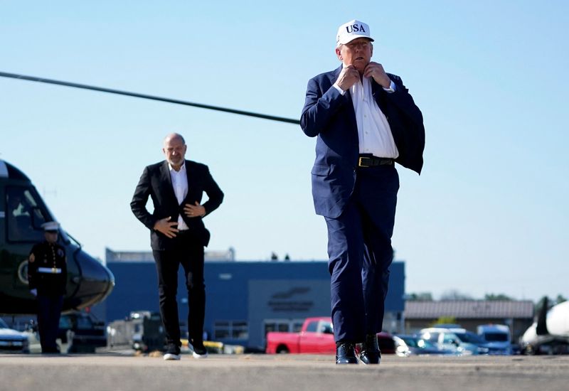 U.S. President Donald Trump and U.S. Secretary of Commerce Howard Lutnick, walk on the tarmac at Morristown Airport, in Morristown, New Jersey, U.S., July 6, 2025. REUTERS/Nathan Howard/File Photo