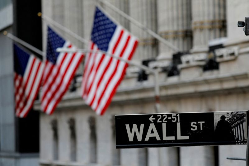 FILE PHOTO: American flags hang from the facade of the New York Stock Exchange (NYSE) building in Manhattan in New York City, New York, U.S., January 28, 2021. REUTERS/Mike Segar/File Photo