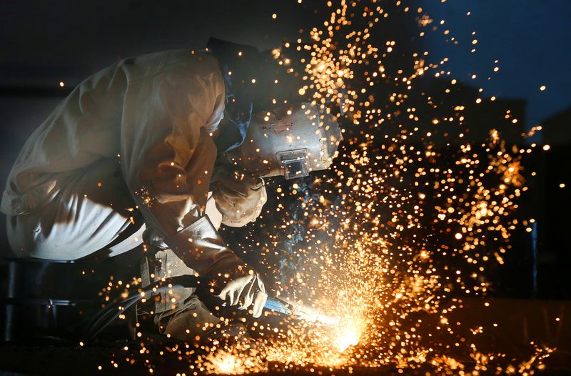 A worker works on a production line at a factory of a ship equipments manufacturer, in Nantong, Jiangsu province, China March 2, 2020. China Daily via REUTERS/File Photo