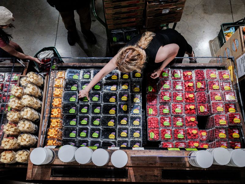 FILE PHOTO: People shop for groceries at a store in New York City, U.S., July 15, 2025. REUTERS/Jeenah Moon/File Photo