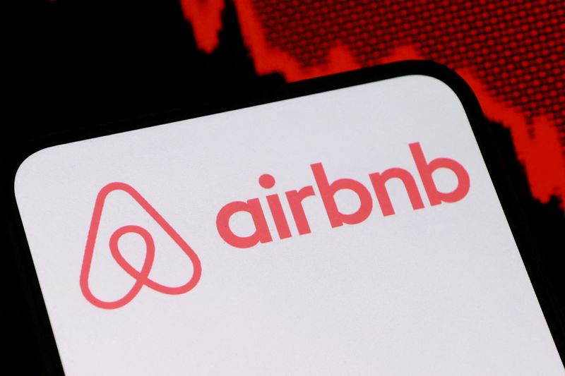 FILE PHOTO: Airbnb logo and decreasing stock graph are seen in this illustration taken August 5, 2025. REUTERS/Dado Ruvic/Illustration/File photo