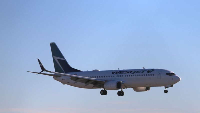 FILE PHOTO: A WestJet Boeing 737-800 airplane lands at Vancouver's international airport in Richmond, British Columbia, Canada, February 5, 2019.  REUTERS/Ben Nelms/File Photo