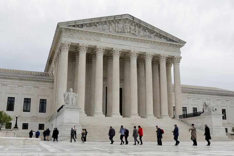 PFILE PHOTO: eople walk across the plaza of the U.S. Supreme Court building on the first day of the court's new term in Washington, U.S. October 3, 2022.  REUTERS/Jonathan Ernst/File Photo