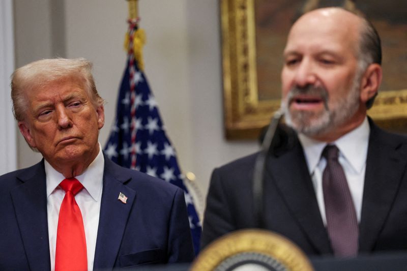 FILE PHOTO: U.S. Commerce Secretary Howard Lutnick speaks next to U.S. President Donald Trump, as they make an announcement about an investment from Taiwan Semiconductor Manufacturing Company (TSMC), in the Roosevelt Room at the White House in Washington, D.C., U.S., March 3, 2025. REUTERS/Leah Millis/File Photo