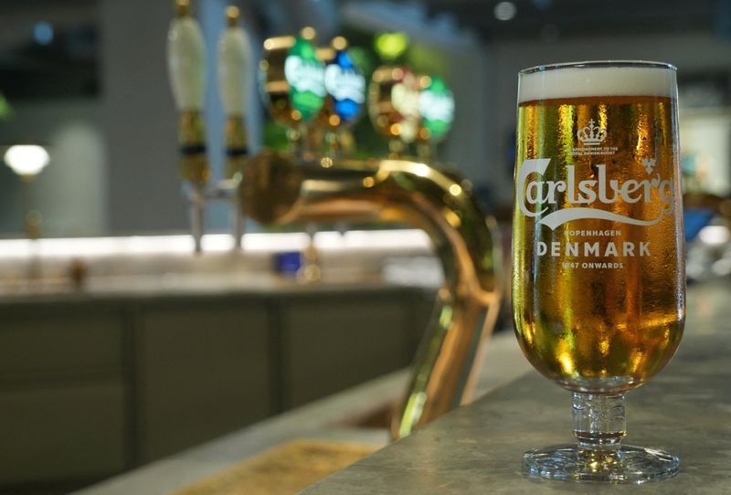 A glass of Carlsberg beer stands on a bar at the 'Home of Carlsberg' exhibit in Copenhagen, Denmark, August 13, 2025. REUTERS/Tom Little