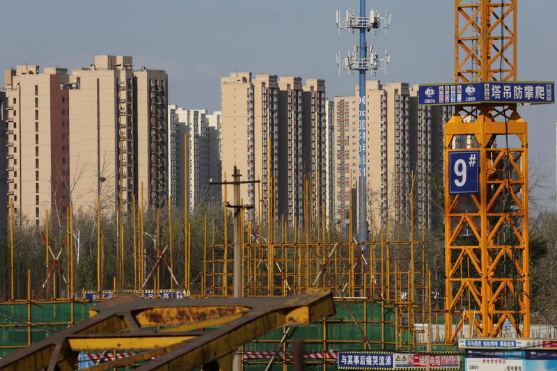 FILE PHOTO: Residential buildings  are pictured near a construction site in Beijing, China April 14, 2022. Picture taken April 14, 2022. REUTERS/Tingshu Wang/File Photo