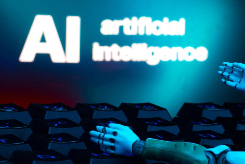 A message reading "AI artificial intelligence", a keyboard, and robot hands are seen in this illustration taken January 27, 2025. REUTERS/Dado Ruvic/Illustration