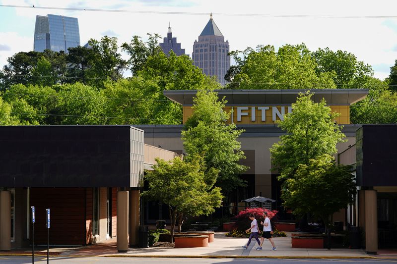 FILE PHOTO: People walk past an LA Fitness gym in Atlanta, Georgia, U.S., April 21, 2020. REUTERS/Elijah Nouvelage/File Photo