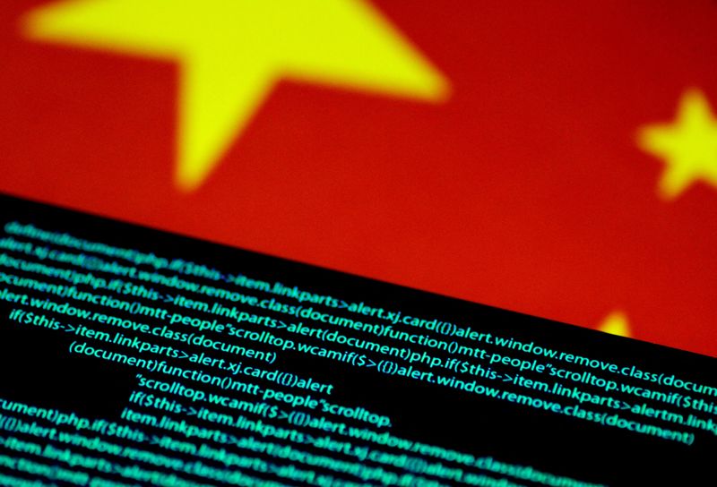 FILE PHOTO: Computer code is seen on a screen above a Chinese flag in this July 12, 2017 illustration photo. REUTERS/Thomas White/Illustration/File Photo