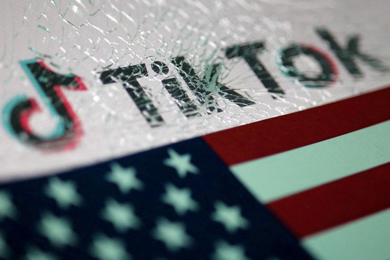 FILE PHOTO: The U.S. flag and the TikTok logo seen through broken glass are seen in this illustration taken January 16, 2025. REUTERS/Dado Ruvic/Illustration/File Photo
