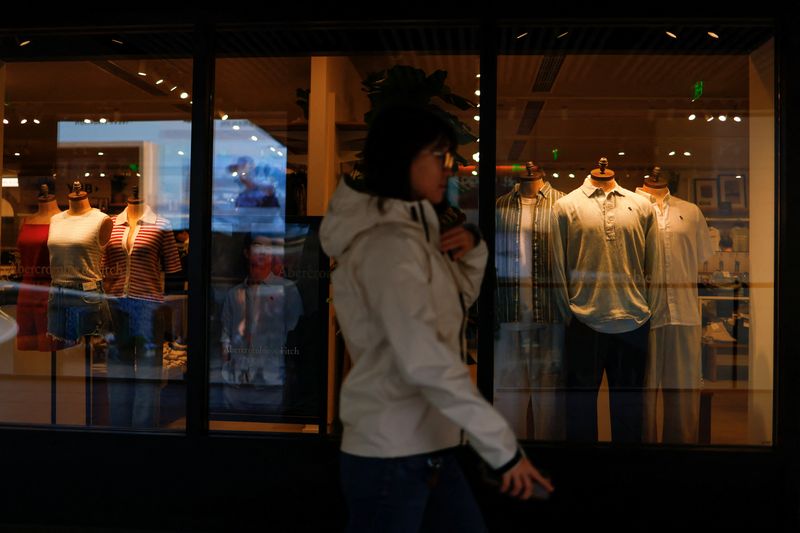 FILE PHOTO: A person walks past an Abercrombie and Fitch store at a shopping compound in Beijing, China April 9, 2025. REUTERS/Tingshu Wang/File Photo