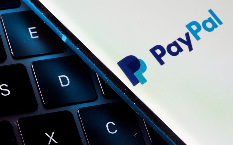 FILE PHOTO: A smartphone with the PayPal logo is placed on a laptop in this illustration taken on July 14, 2021. REUTERS/Dado Ruvic/Illustration/File Photo