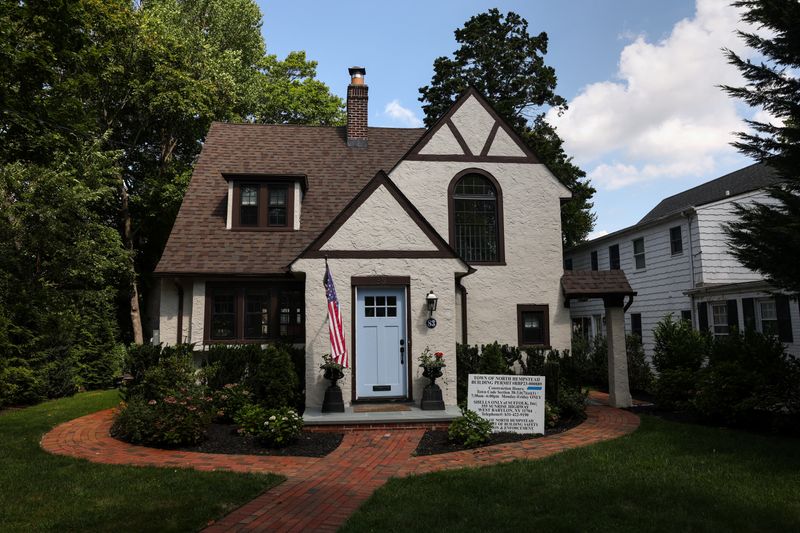 FILE PHOTO: A Town of North Hempstead building permit stands in front of a home on the North Shore of Long Island city of Manhasset, New York, U.S., August 13, 2025. REUTERS/Shannon Stapleton/File Photo
