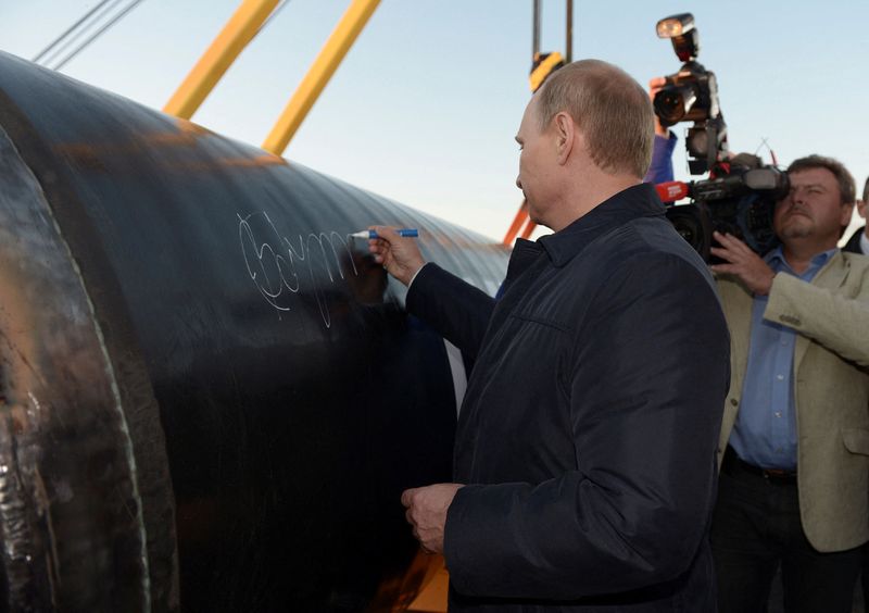 FILE PHOTO: Russia's President Vladimir Putin signs on the first segment of pipeline during a ceremony marking the start of construction of "Power of Siberia" pipeline at the village of Us Khatyn, September 1, 2014. REUTERS/Alexei Nikolsky/RIA Novosti/Kremlin/File Photo