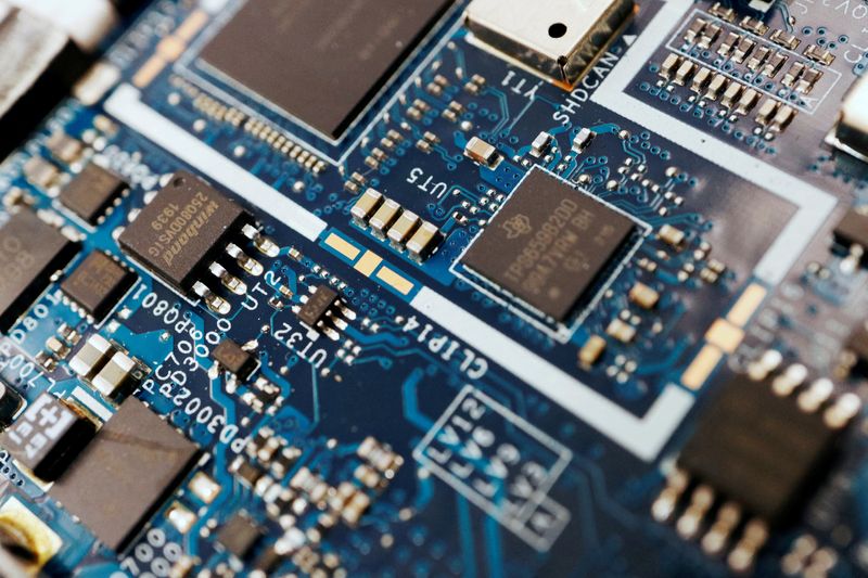 FILE PHOTO: Semiconductor chips are seen on a circuit board of a computer in this illustration picture created on February 25, 2022. REUTERS/Florence Lo/Illustration/File Photo