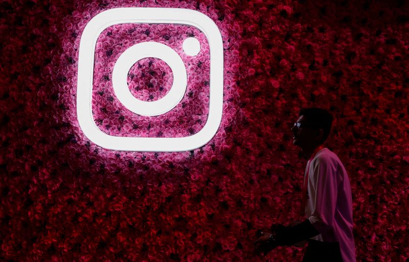 FILE PHOTO: A man walks past a logo of mobile application Instagram, during a conference in Mumbai, India, September 20, 2023. REUTERS/Francis Mascarenhas/File Photo