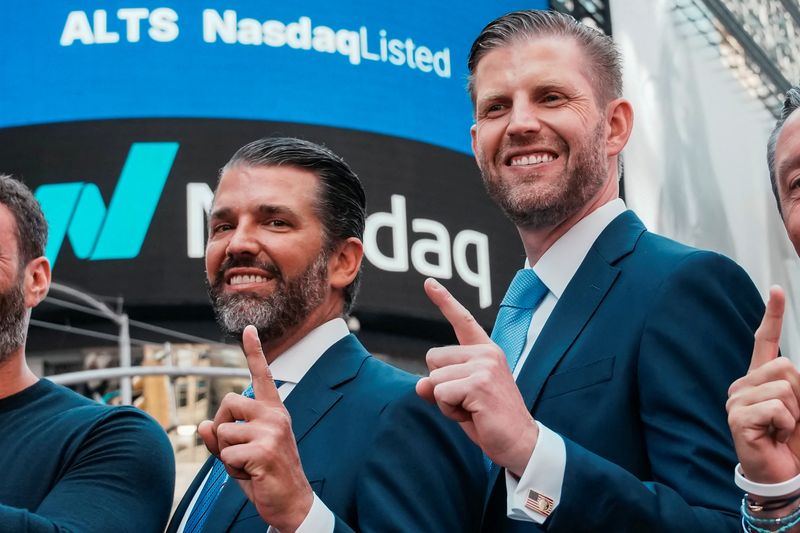 FILE PHOTO: Donald Trump Jr. and Eric Trump gesture outside the Nasdaq building after ringing the opening bell to celebrate the closing of ALT5’s $1.5 billion offering and adoption of its $WLFI Treasury Strategy at the Nasdaq Market, in New York City, U.S., August 13, 2025.  REUTERS/Eduardo Munoz/File Photo
