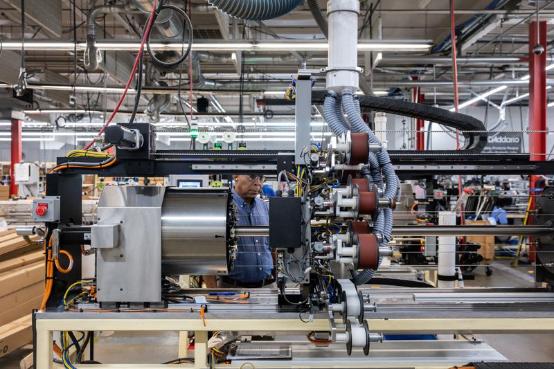 A worker operates a machine at D'Addario's instrument strings production facility in Farmingdale, New York, U.S., July 10, 2025. REUTERS/Kylie Cooper/File Photo