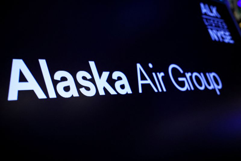 FILE PHOTO: A screen displays the logo of Alaska Air Group on the floor at the New York Stock Exchange (NYSE) in New York City, U.S., December 4, 2023.  REUTERS/Brendan McDermid/File Photo