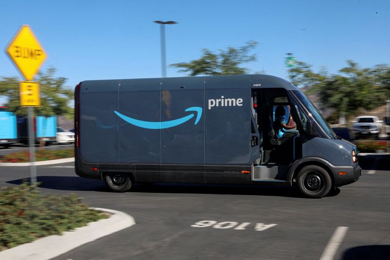 FILE PHOTO: An electric Rivian truck purchased by Amazon is pictured working on delivery from the Amazon facility in Poway, California, U.S., November 16, 2022. REUTERS/Sandy Huffaker/File Photo