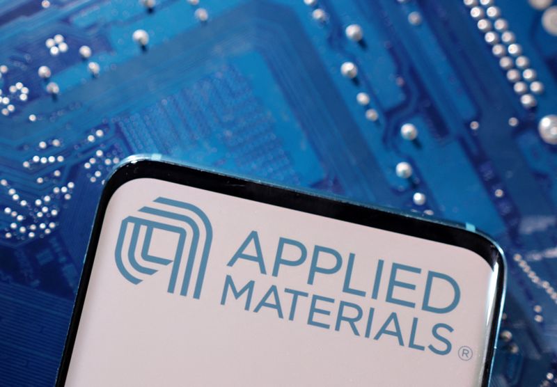 A smartphone with a displayed Applied Materials logo is placed on a computer motherboard in this illustration taken March 6, 2023. REUTERS/Dado Ruvic/Illustration