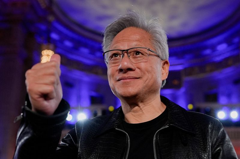 FILE PHOTO: Nvidia CEO Jensen Huang gestures as U.S. President Donald Trump (not pictured) delivers remarks during the "Winning the AI Race" Summit in Washington D.C., U.S., July 23, 2025. REUTERS/Kent Nishimura/File Photo