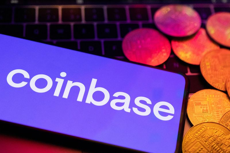 A smartphone with displayed Coinbase logo and representation of cryptocurrencies are placed on a keyboard in this illustration taken, June 8, 2023. REUTERS/Dado Ruvic/Illustration