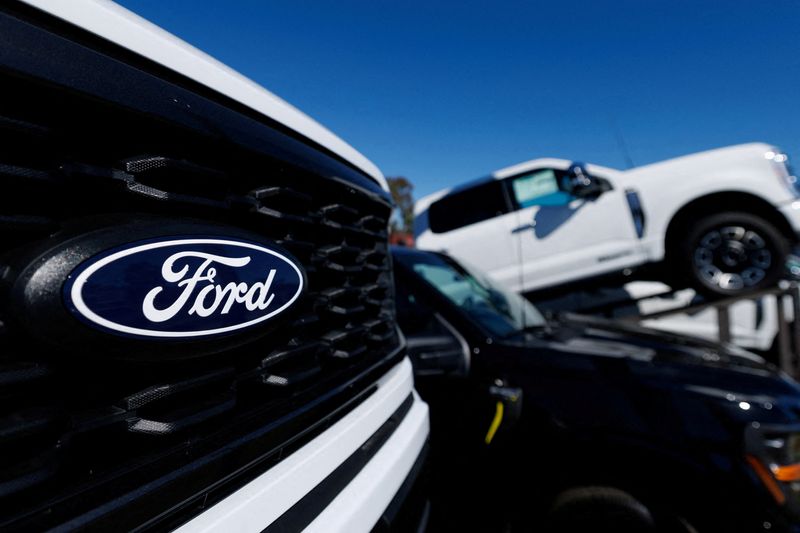 FILE PHOTO: A Ford logo on a Ford F-150 pickup truck for sale in Encinitas, California, U.S. October 20, 2025. REUTERS/Mike Blake/File Photo