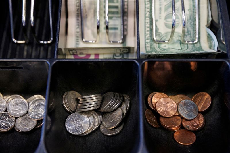 FILE PHOTO: Pennies and other U.S. currency denominations in a cash register at a QuikTrip in Dallas, Texas, U.S., October 23, 2025. The U.S. Treasury has stopped making pennies, causing some businesses to have to create new workarounds for cash transactions. REUTERS/Shelby Tauber/File Photo