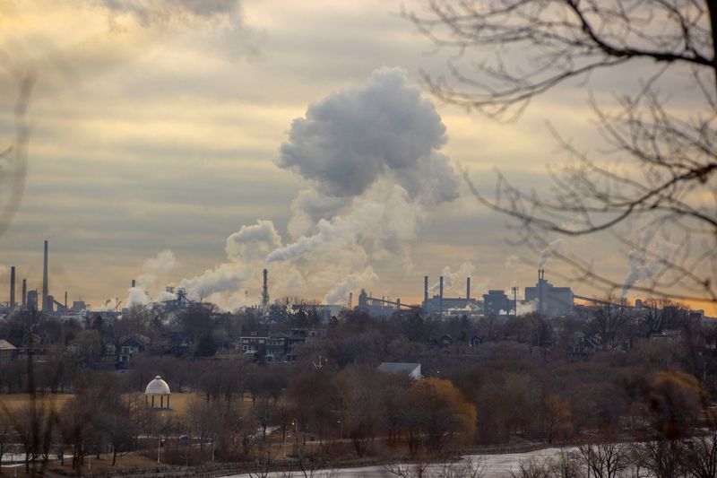 Emissions billows from an industrial sector housing steel companies in Hamilton, Ontario, Canada, March 13, 2025. REUTERS/Carlos Osorio