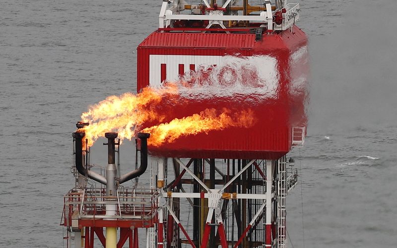 FILE PHOTO: A Lukoil company sign at the Filanovskogo oil platform in the Caspian Sea, Russia, October 16, 2018. REUTERS/Maxim Shemetov/File Photo