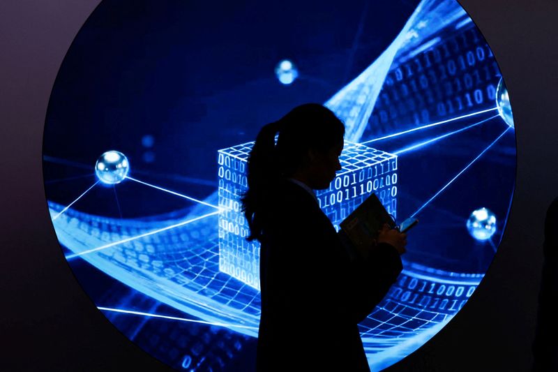 A woman walks past an illustration of internet at the expo of the World Internet Conference in Wuzhen town of Tongxiang city, Zhejiang province, China November 8, 2025. REUTERS/Tingshu Wang