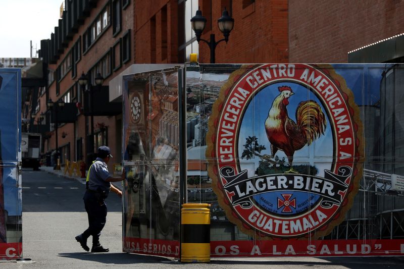 A security guard opens the gate of the brewery Cerveceria Centro Americana of Guatemalan conglomerate Castillo Hermanos, in Guatemala City, Guatemala April 3, 2025. REUTERS/Josue Decavele