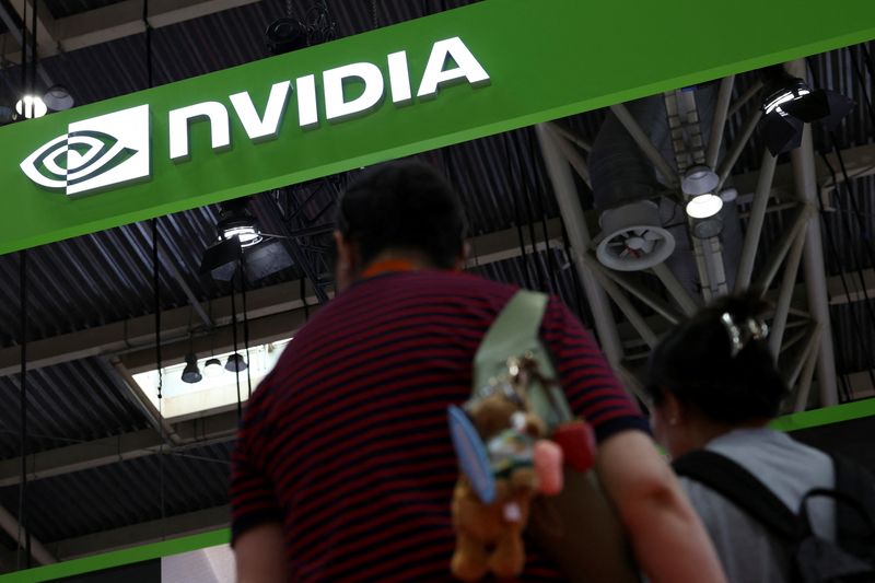 People stand near the Nvidia logo at its booth during the China International Supply Chain Expo in Beijing, China July 16, 2025. REUTERS/Florence Lo