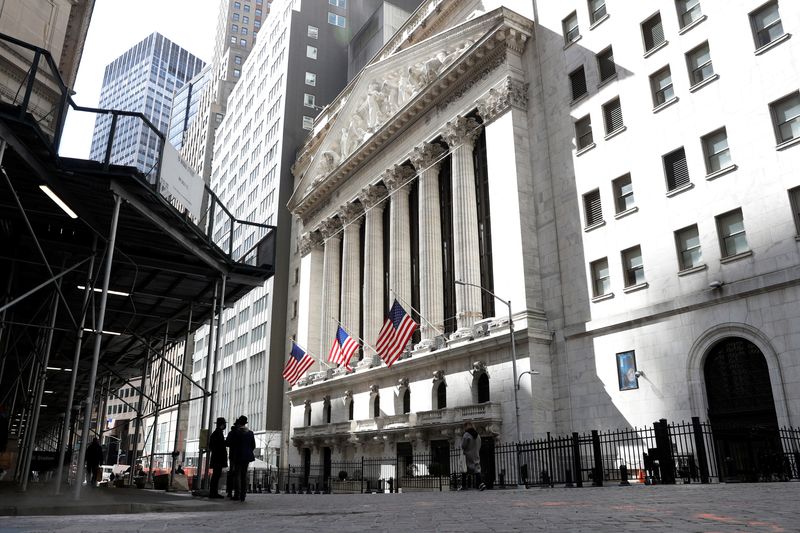 People are seen on Wall St. outside the New York Stock Exchange (NYSE) in New York City, U.S., March 19, 2021.  REUTERS/Brendan McDermid