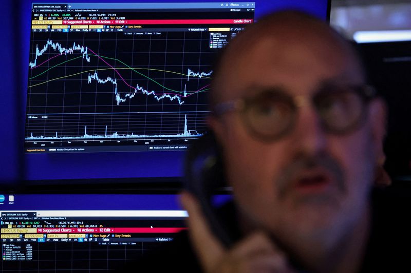 FILE PHOTO: A trader works on the floor at the New York Stock Exchange (NYSE) in New York City, U.S., October 29, 2025.  REUTERS/Brendan McDermid/File Photo
