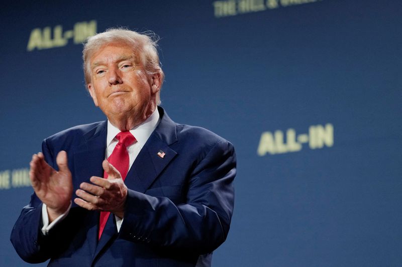 FILE PHOTO: U.S. President Donald Trump applauds at the "Winning the AI Race" Summit in Washington D.C., U.S., July 23, 2025. REUTERS/Kent Nishimura/File Photo