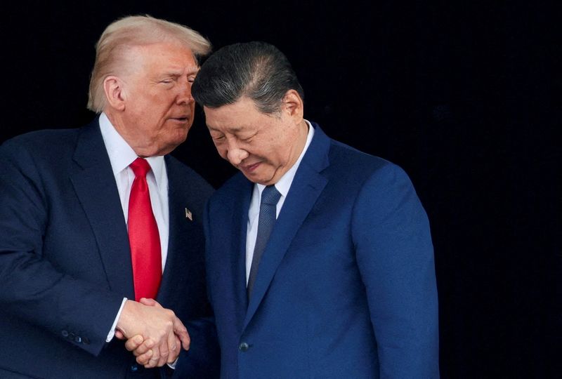 FILE PHOTO: U.S. President Donald Trump and Chinese President Xi Jinping talk as they leave after a bilateral meeting at Gimhae International Airport, on the sidelines of the Asia-Pacific Economic Cooperation (APEC) summit, in Busan, South Korea, October 30, 2025. REUTERS/Evelyn Hockstein/File Photo