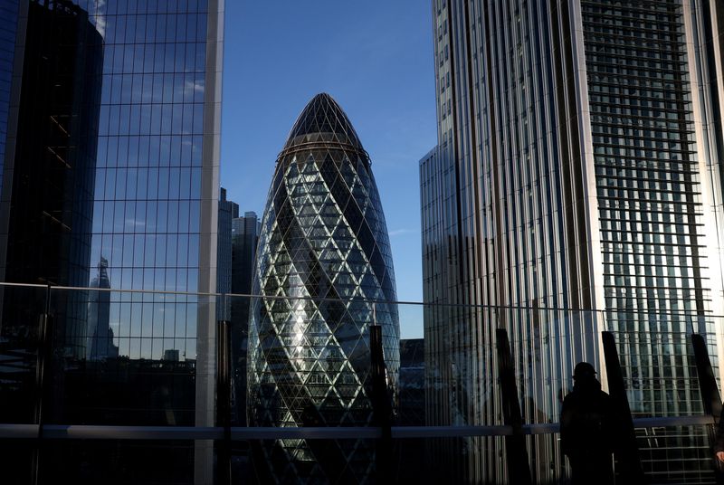 A person looks out from a rooftop garden in the City of London business district with Gherkin skyscraper seen behind, as Britain’s Chancellor Rachel Reeves faces tough financial decisions ahead of her second budget statement next week, in London, Britain, November 21, 2025. REUTERS/Toby Melville