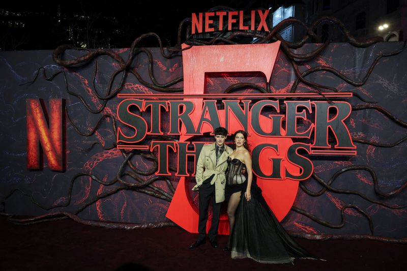 Cast members Noah Schnapp and Millie Bobby Brown attend the screening for the final season of the television series "Stranger Things", at Odeon Luxe Leicester Square in London, Britain, November 13, 2025. REUTERS/Isabel Infantes