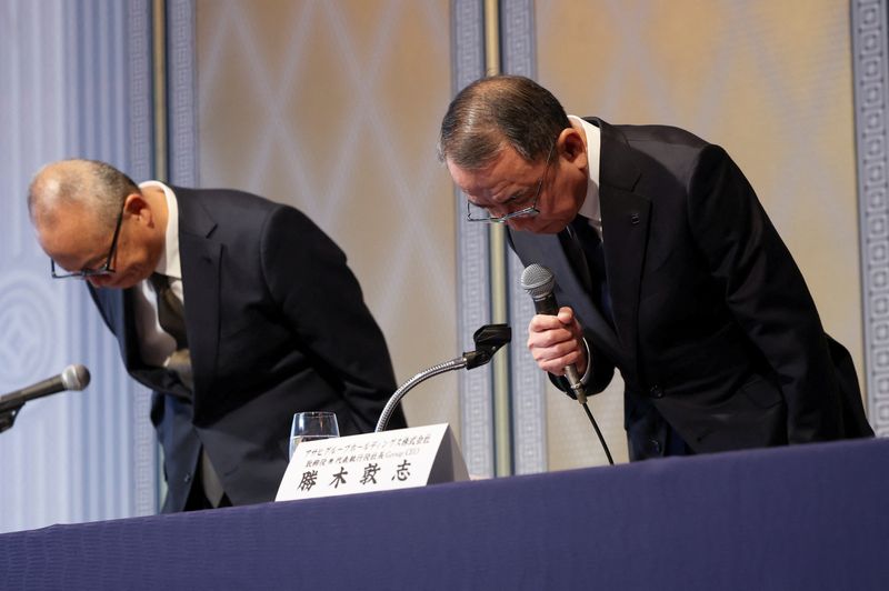 Asahi Group Holdings President and Group CEO Atsushi Katsuki and Group CFO Kaoru Sakita bow during a press conference on the results of the investigation into the crippling cyberattack, which forced a widespread suspension of operations for the beverage maker, in Tokyo, Japan, November 27, 2025.  REUTERS/Issei Kato