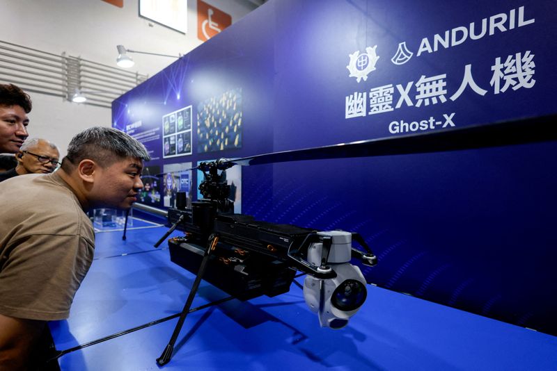 FILE PHOTO: Visitors look at the Ghost-X unmanned aerial vehicle developed by U.S. company Anduril, during the Taipei Aerospace and Defence Technology Exhibition in Taipei, Taiwan, September 19, 2025. REUTERS/Ann Wang/File Photo